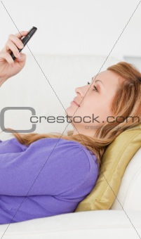 Profile portrait of a good looking woman writing a text message 