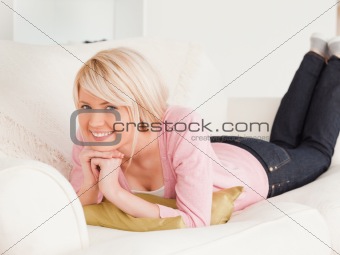 Young pretty woman posing while lying on a sofa