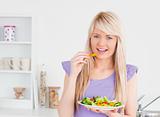 Smiling woman eating her salad