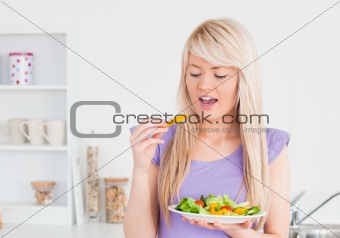 Happy female eating her salad 