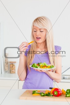 Happy woman eating her salad 