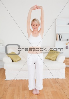 Beautiful woman stretching in the living room