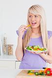 Attractive smiling woman enjoying her salad
