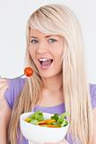 Gorgeous smiling woman eating her salad
