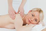 Closeup of young beautiful blonde female receiving a back massag