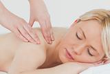Closeup of young beautiful blonde woman receiving a back massage