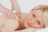 Closeup of young pretty blonde woman receiving a back massage