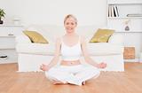 Delighted blonde woman practicing yoga