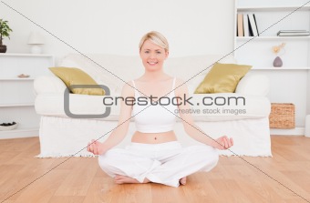 Delighted blonde woman practicing yoga