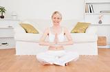 Cute blonde woman practicing yoga