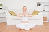 Pretty blond-haired woman practicing yoga