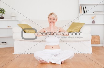 Pretty blond-haired woman practicing yoga