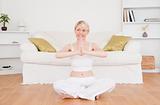 Attractive blond-haired woman practicing yoga