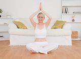 Cute blond-haired woman practicing yoga
