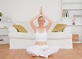 Relaxed blond-haired woman practicing yoga
