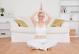 Happy blond-haired woman practicing yoga