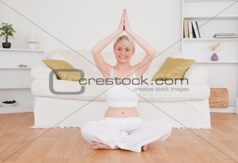 Happy blond-haired woman practicing yoga