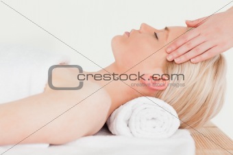 Pretty blonde woman enjoying her treatment in a Spa centre