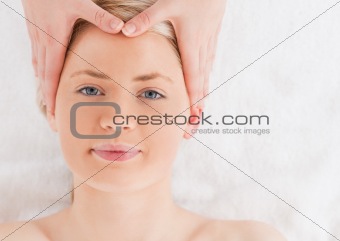 Pretty young woman getting a massage on her face in a Spa centre