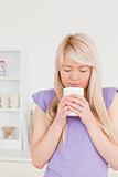 Attractive blonde woman drinking hot drink