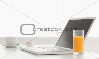 Modern and stylish laptop on a table while breakfast time