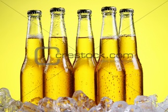 Glass of beer with foam on yellow background