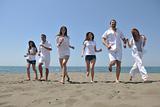 happy people group have fun and running on beach