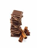 Chocolate bars stack and cinnamon sticks 