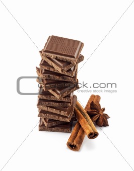 Chocolate bars stack and cinnamon sticks 