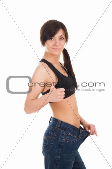 Young woman in her old jeans after losing weight
