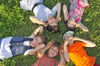 children laying together on ground
