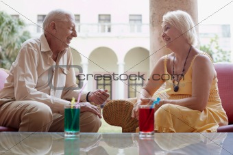 old man and woman drinking in hotel 's bar