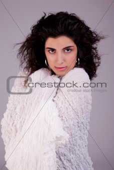 beautiful young woman , wrapped in a white blanket, studio shot