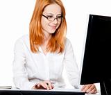 Smiling young business woman using computer 