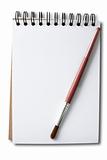 Brush handle in red on a white sketch book