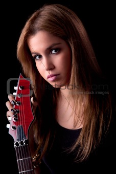 beautiful young woman with a electric guitar, on black, studio shot
