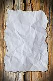 white crumpled paper and border burn on wood background