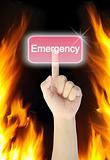 hand pressing emergency button on fire background