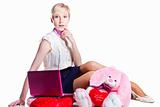 blond girl working with pink laptop on isolated white