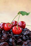 dried cherry and fresh cherries on a brown background