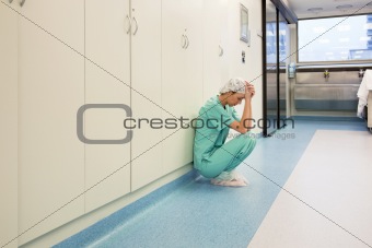 Upset surgeon sitting alone