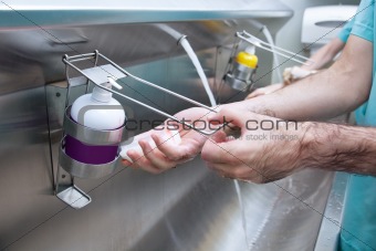 Man washing his hand with hand sanitizer
