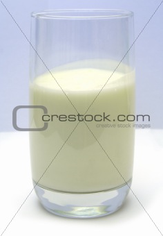 Glass with kefir on smooth white table