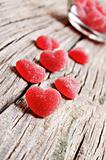 Red heart shaped jelly sweets on a rustic background