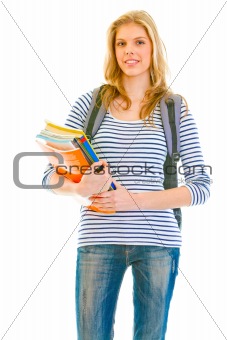 Smiling young girl with schoolbag holding schoolbooks in hands
