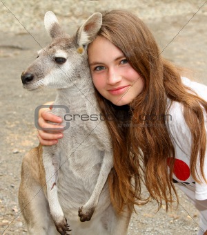 young girl hugging a kangaroo