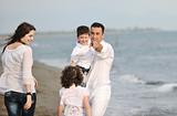 happy young family have fun on beach