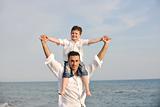 happy father and son have fun and enjoy time on beach