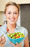 Happy young woman with salad