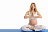 pregnant woman with closed eyes practicing yoga